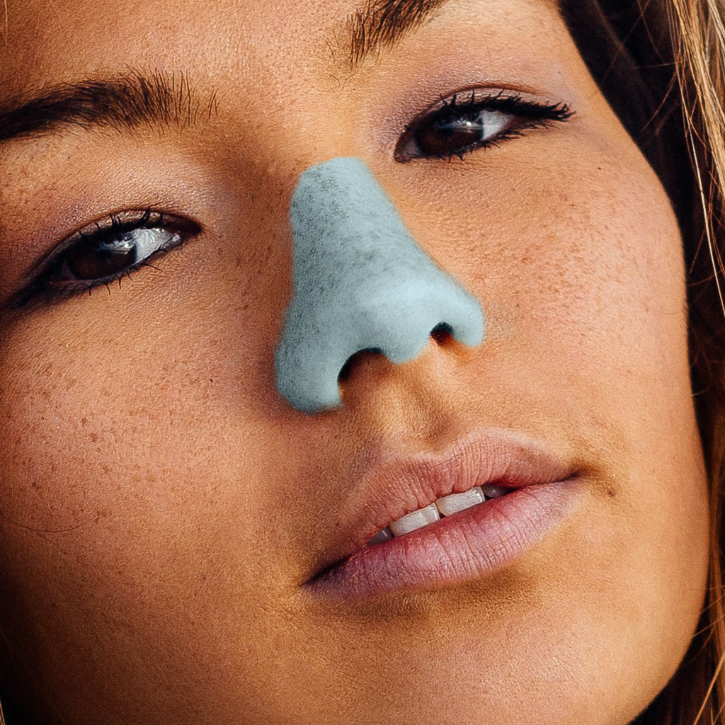 Client wearing the Noz colorful sunscreen on nose in blue